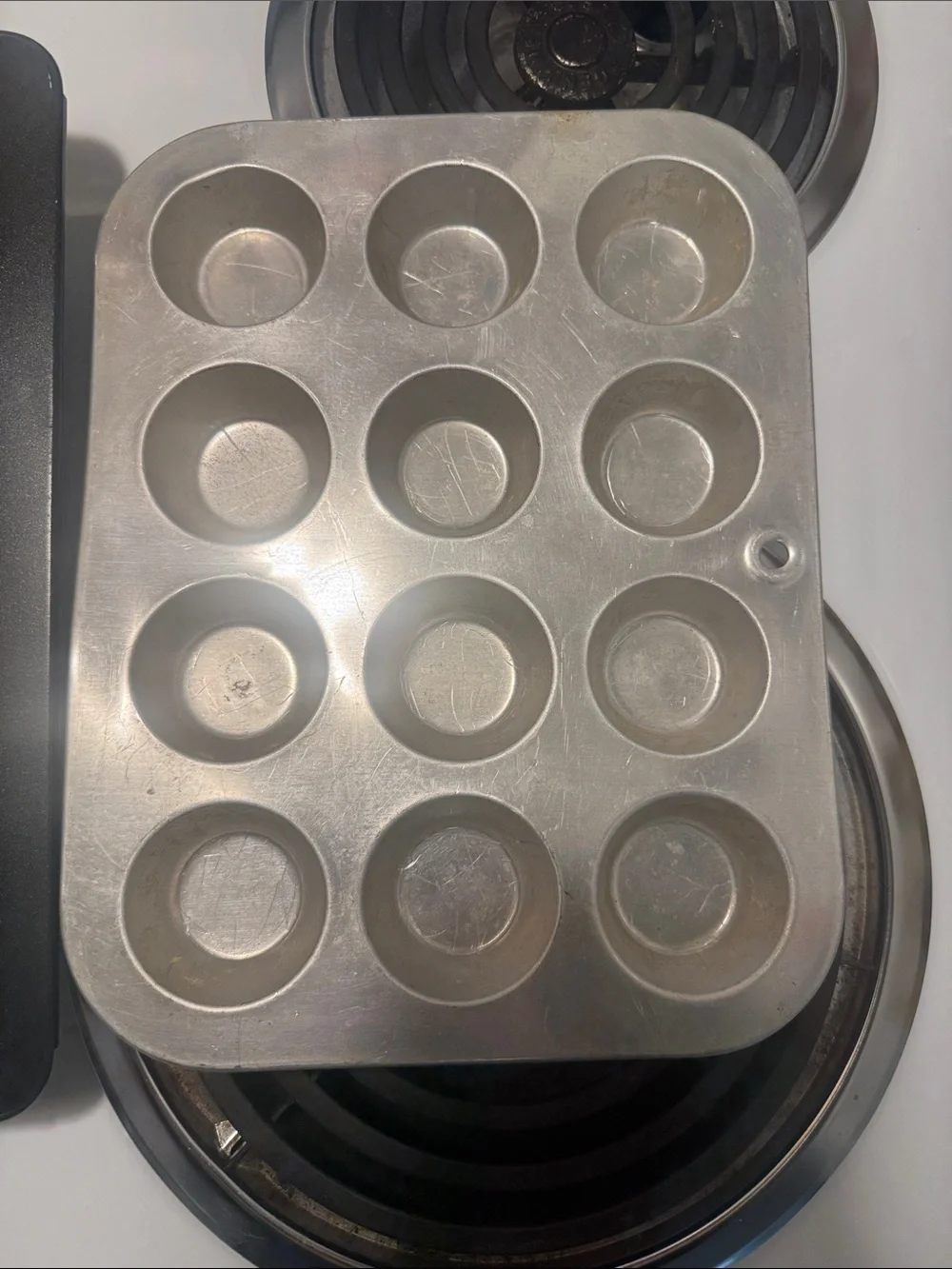 Two muffin pans, the large one is non-stick and NWOT. Small one is in GUC.